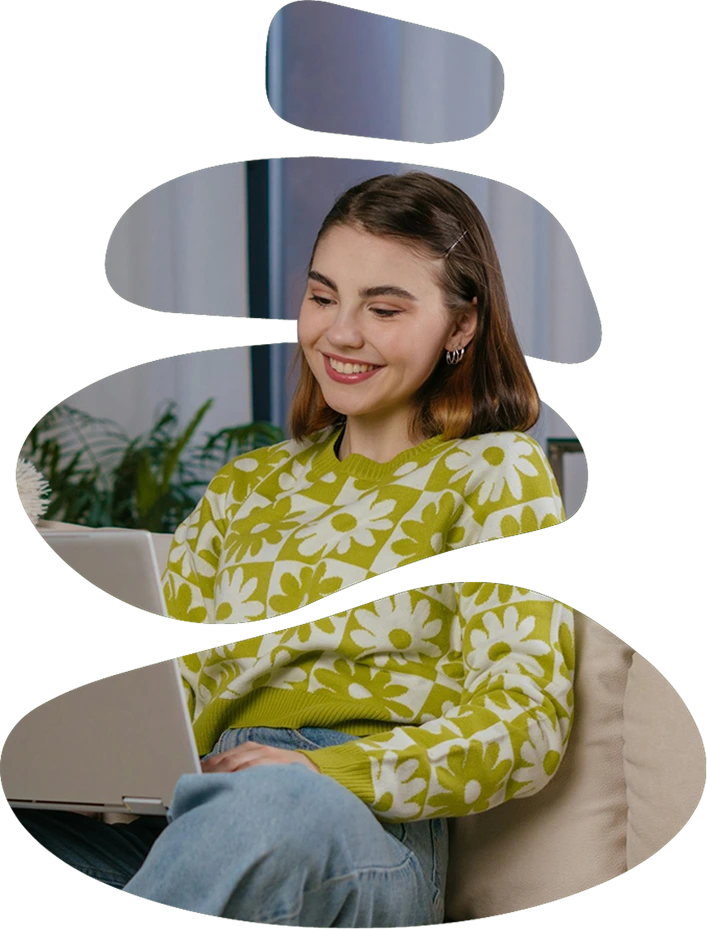 A young woman in a green floral sweater sits on a couch, smiling at her laptop. The image is sliced into horizontal segments.